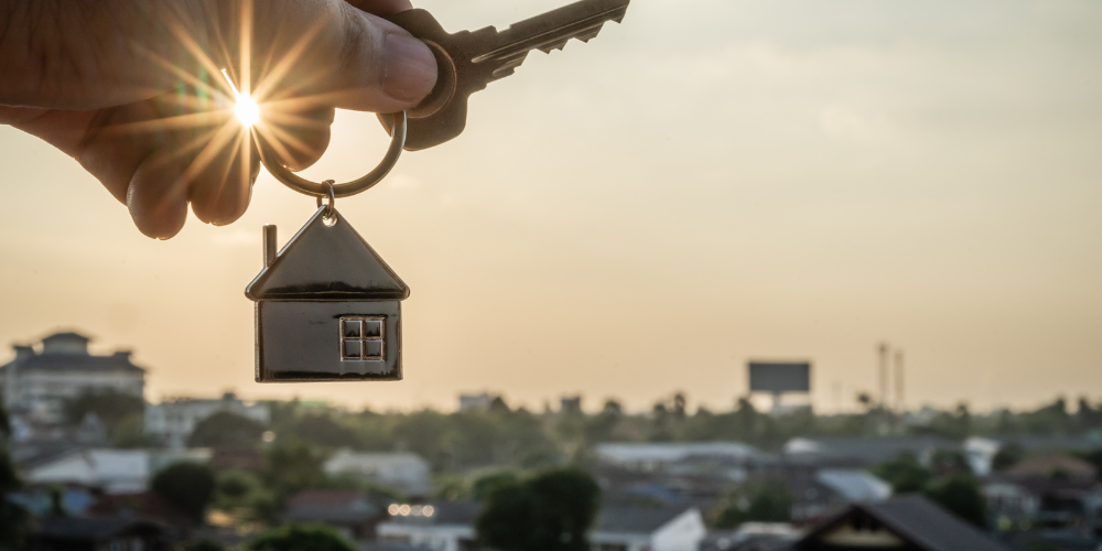 House key chain being held over the horizon