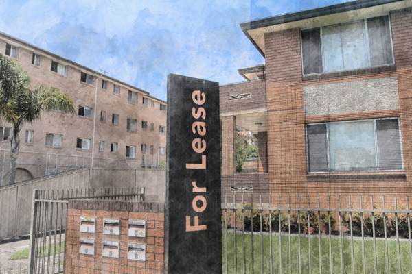image of an apartment unit block with for lease sign out front