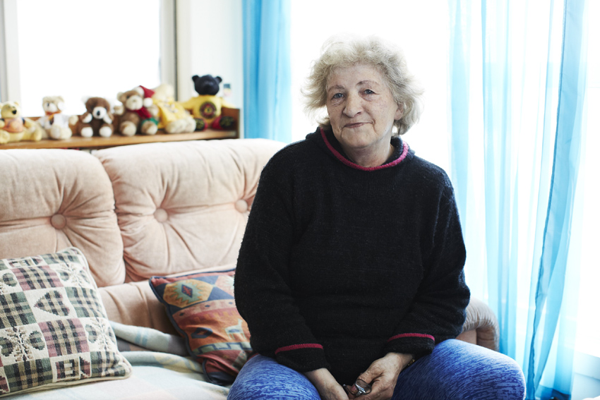 Older woman sitting on a couch - report cover