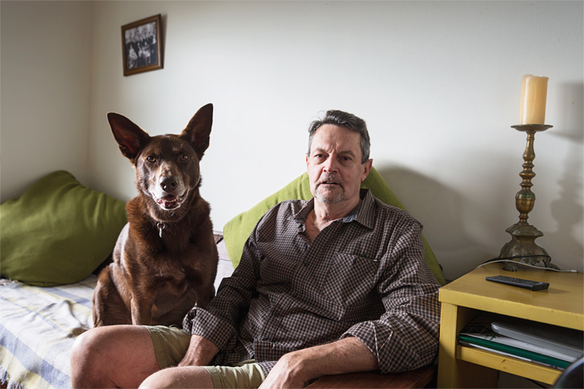 Brian and his dog Ruby, sitting on their couch