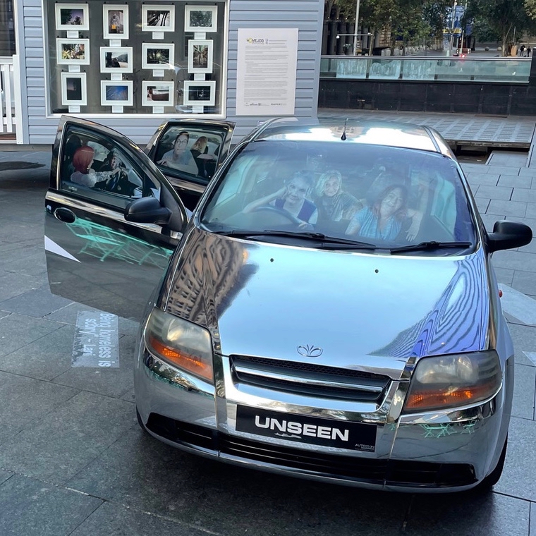 UNSEEN chrome car art installation. Three women profiles are seen - barely - in the car seats. 