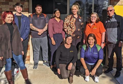 Group photo of 9 people, 7 standing and 2 kneeling. They are staff of the Tenants' Union of NSW and Murra Mia Aboriginal Tenants Advice Service. 